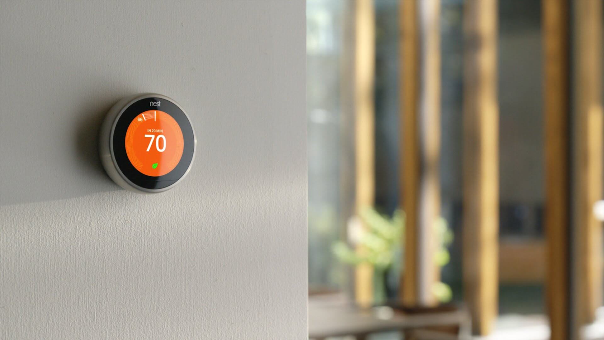 Smart thermostat on a wall showing 70 degrees fahrenheit